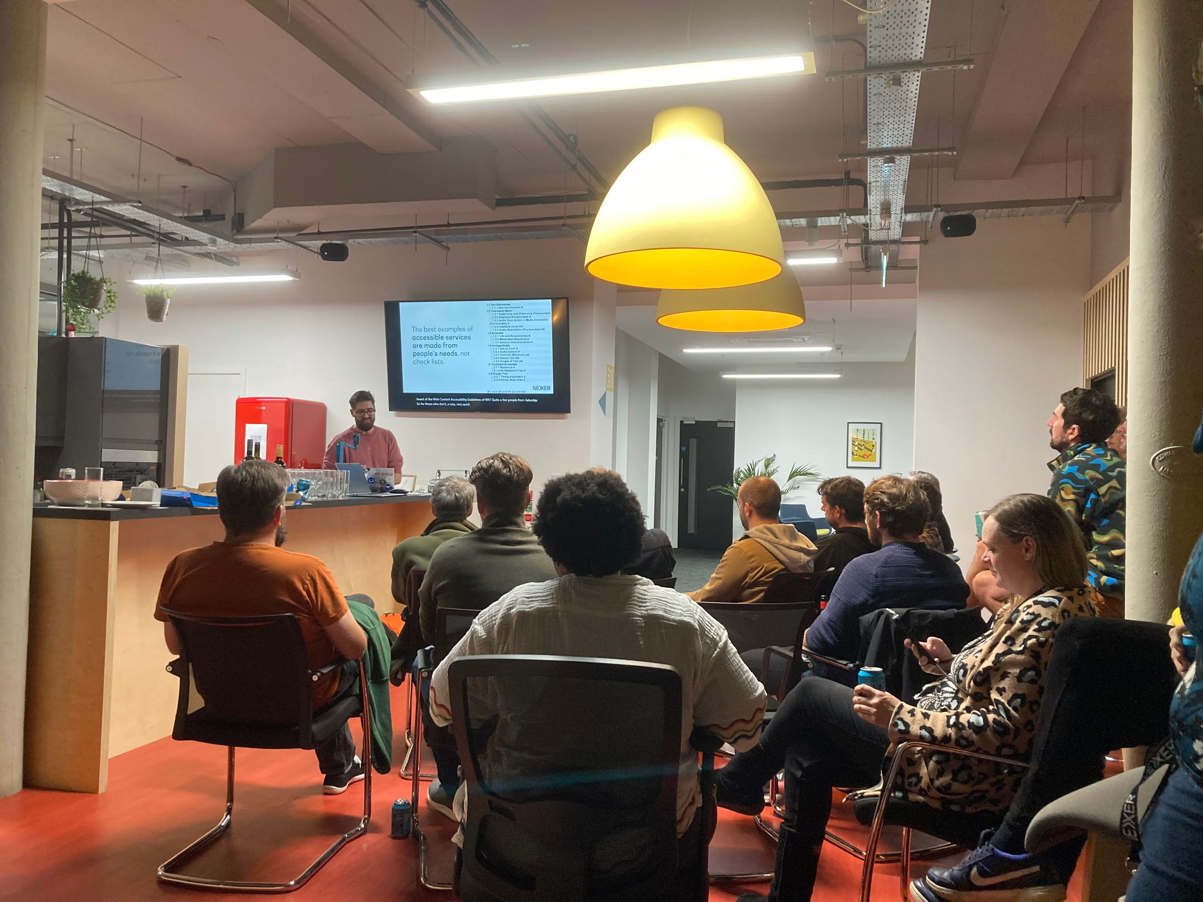 Danny Lancaster presenting to an audience at Macc Tech