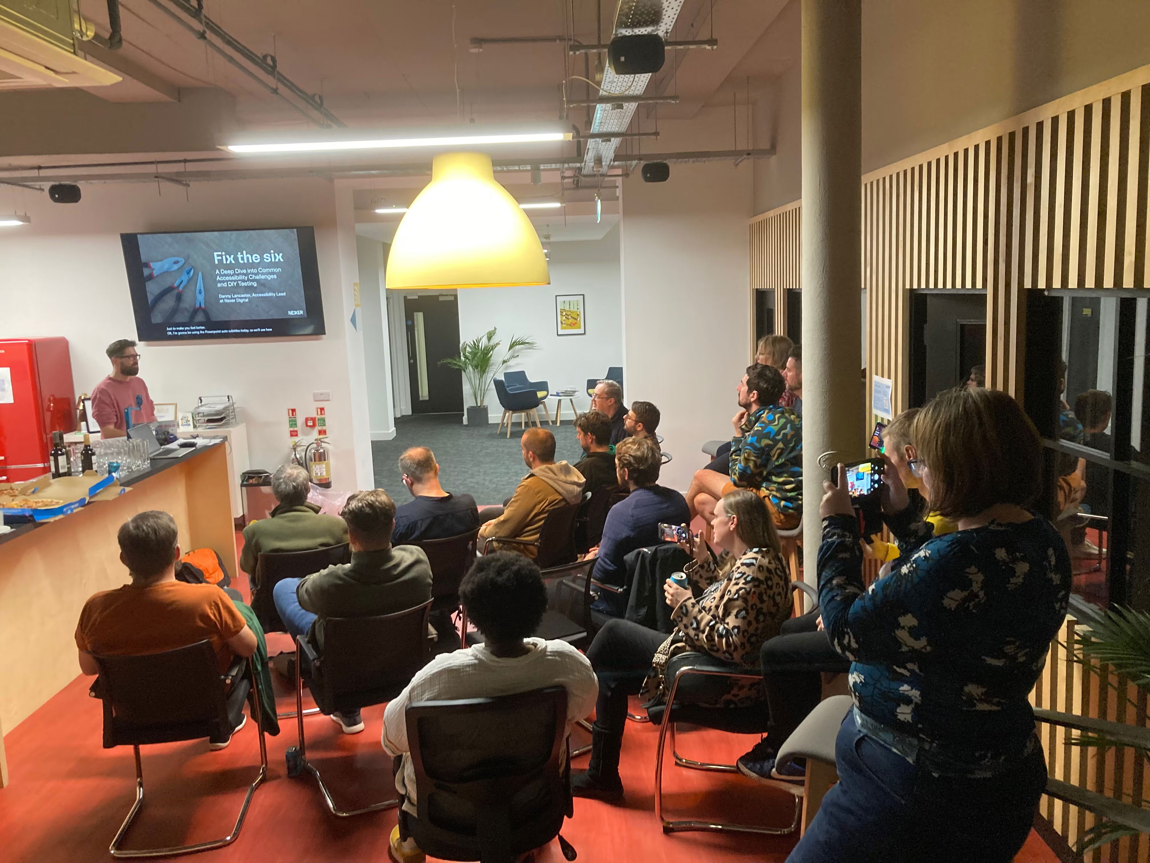 Danny Lancaster presenting to an audience at Macc Tech