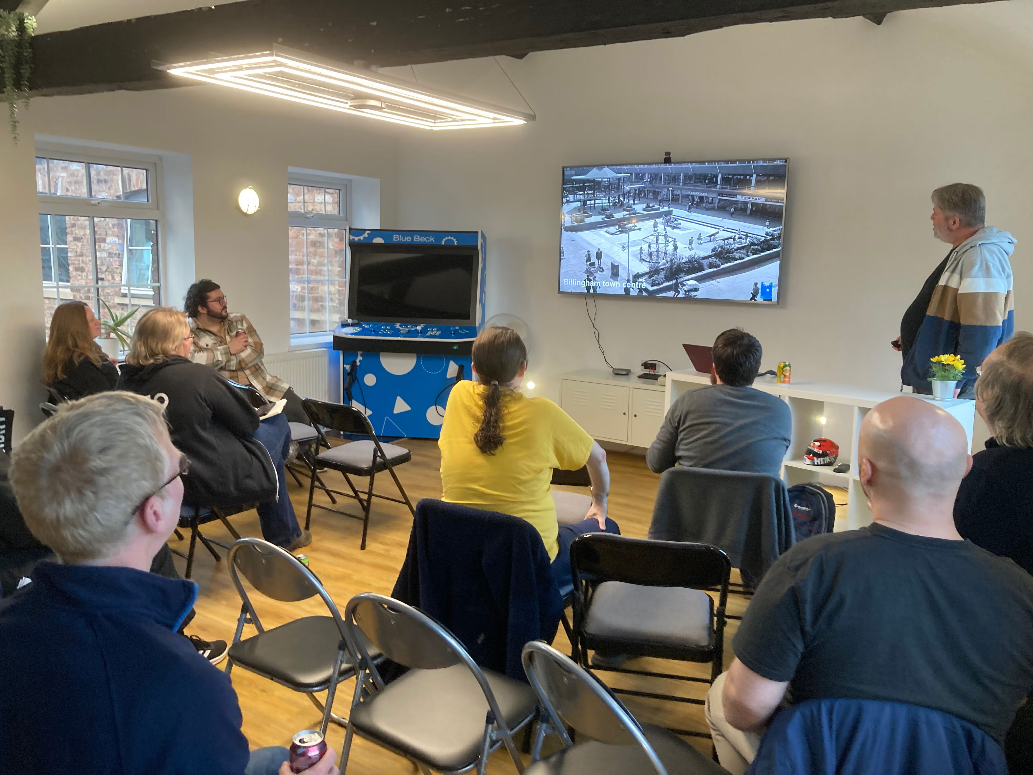 Pete Scott presenting. Picture of Billingham on the screen.