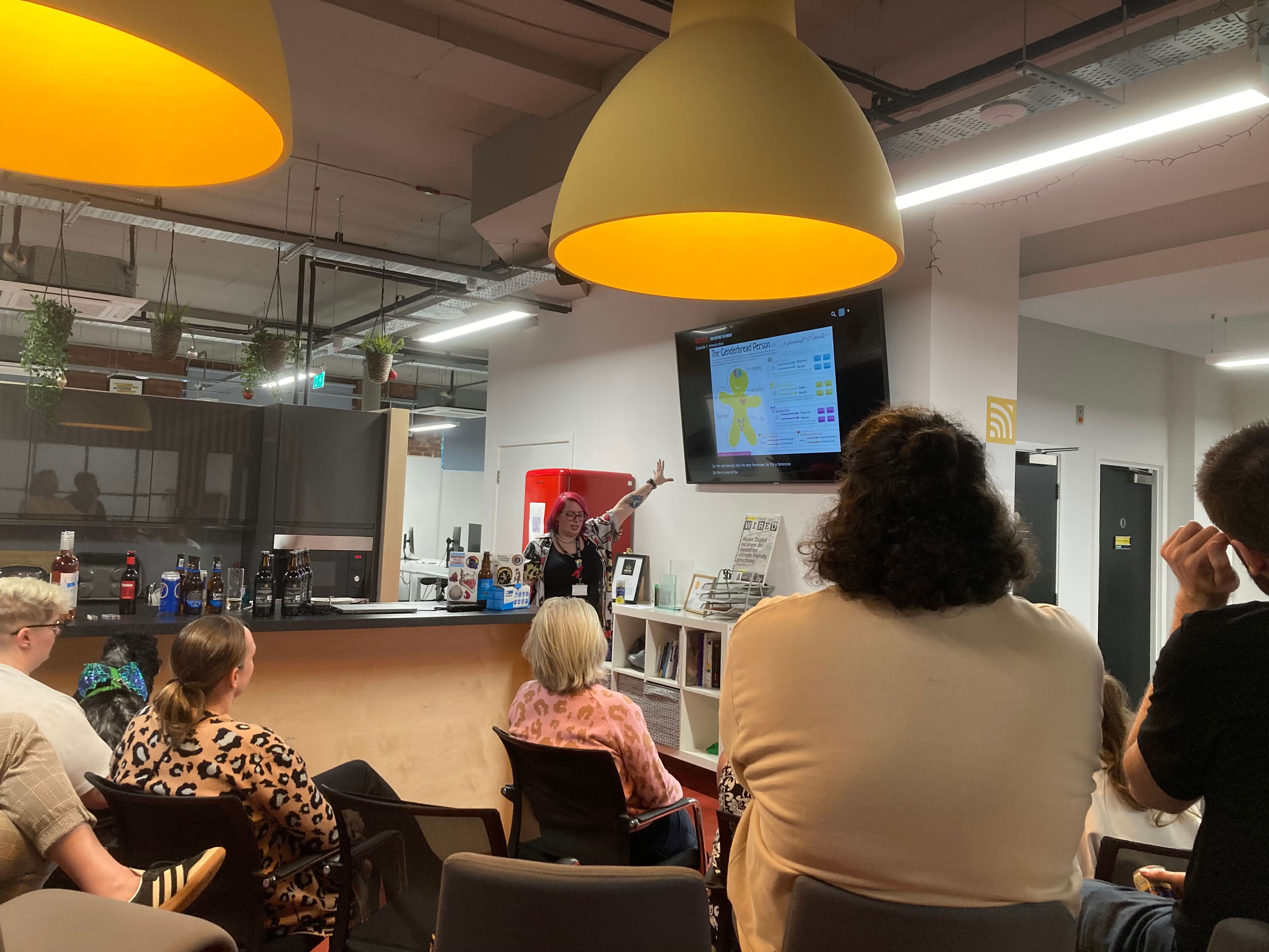 Tracey pointing at the screen. Audience watching on