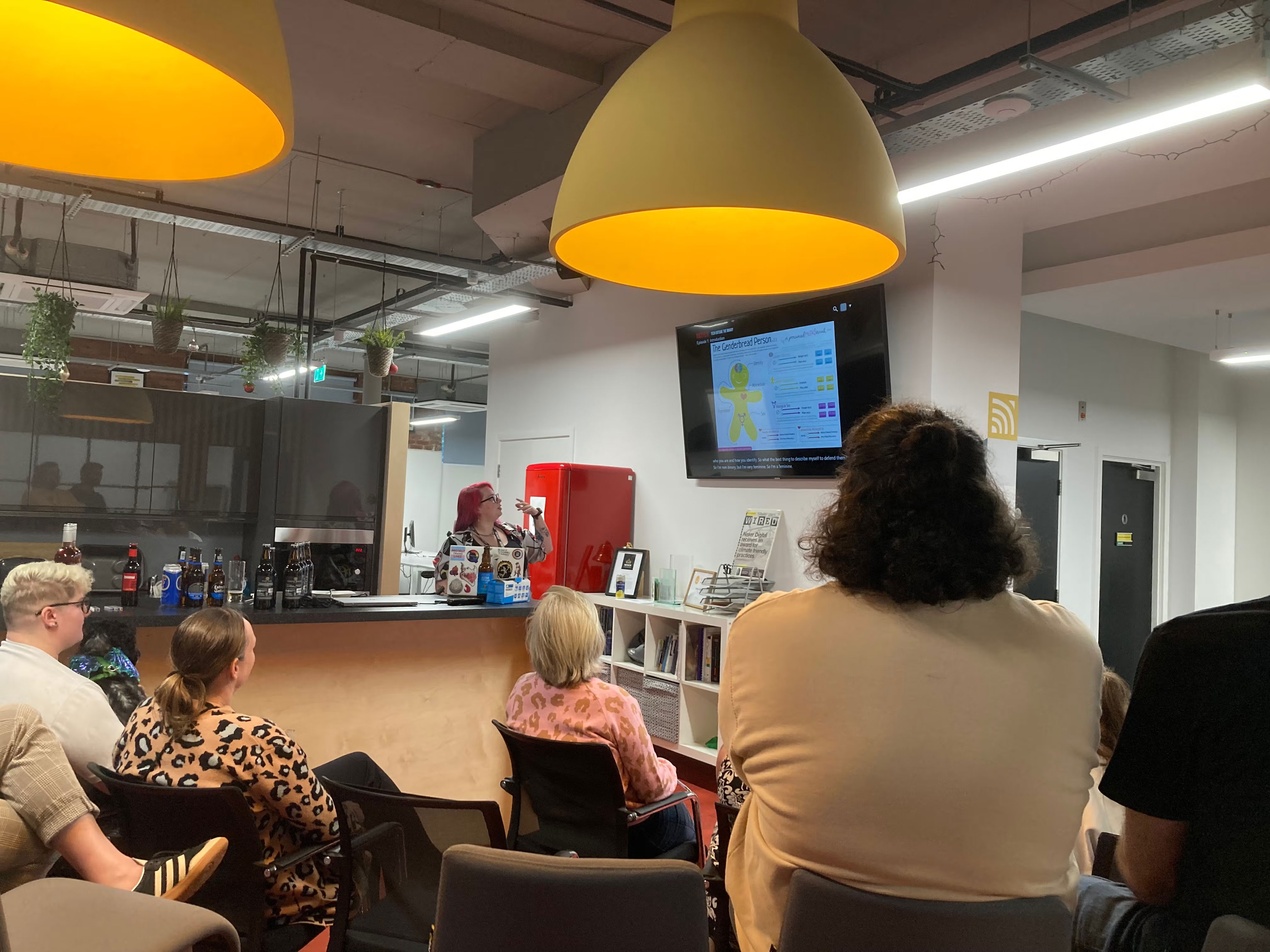 Tracey looking at the screen, explaining something in the presentation, as the audience watch.
