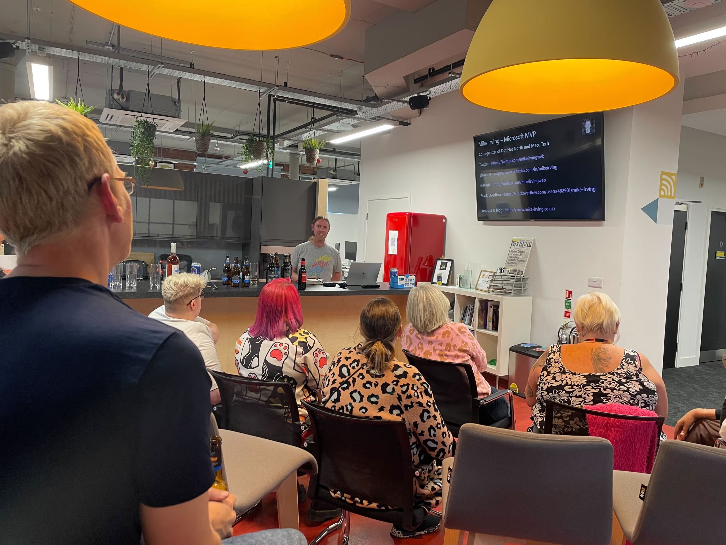 Mike introducing himself before his talk, audience watching.