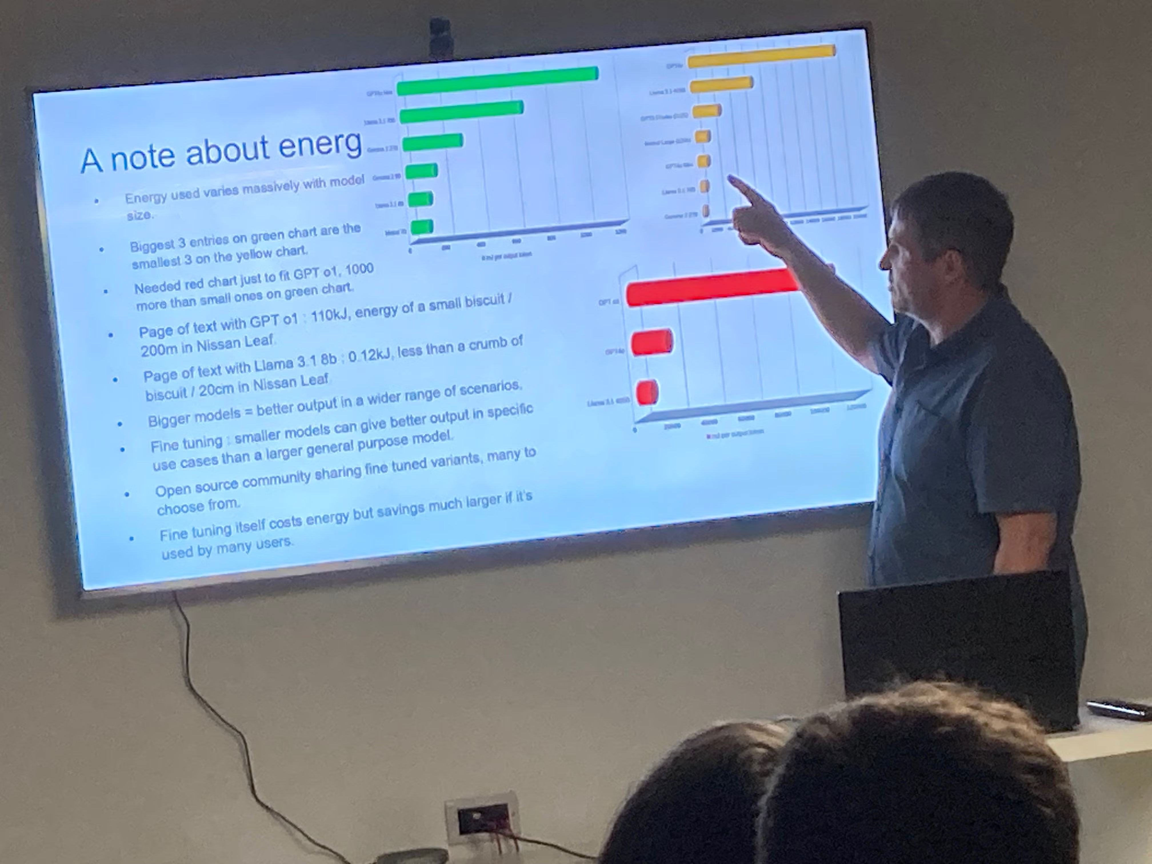 Richard presenting, pointing at a chart on his slides