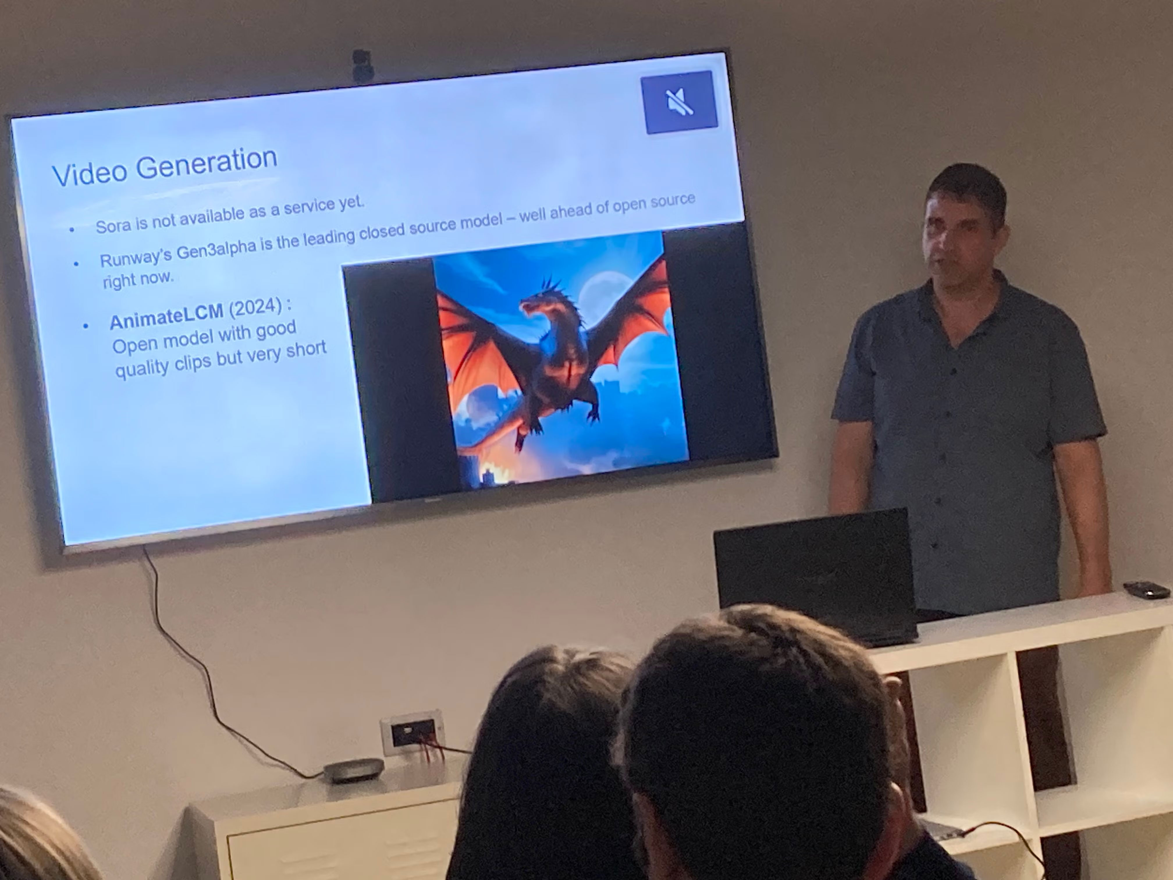 Richard presenting, aside a big screen. Screen reads 'Video Generation'