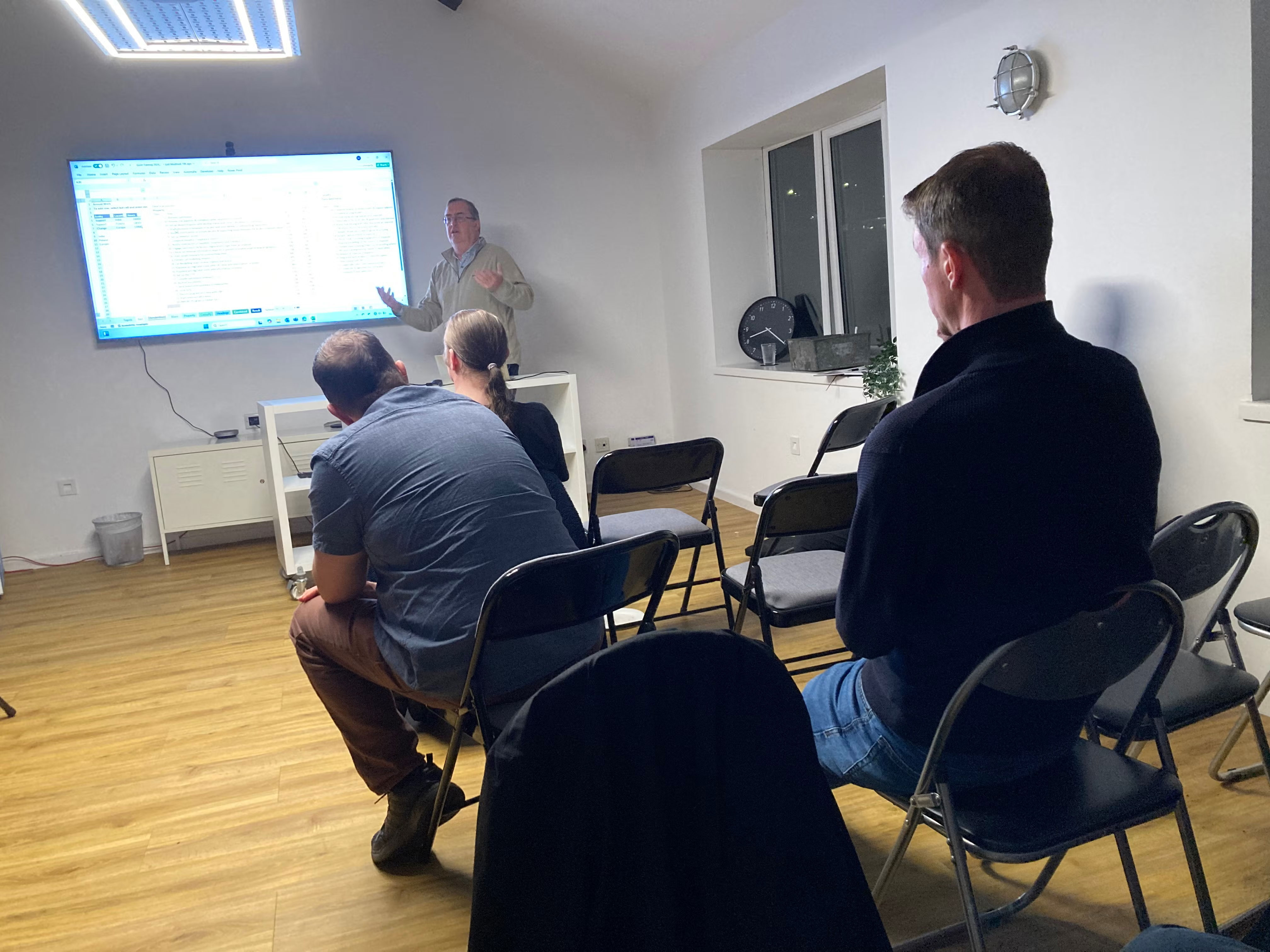 Side of audience view of Nick presenting