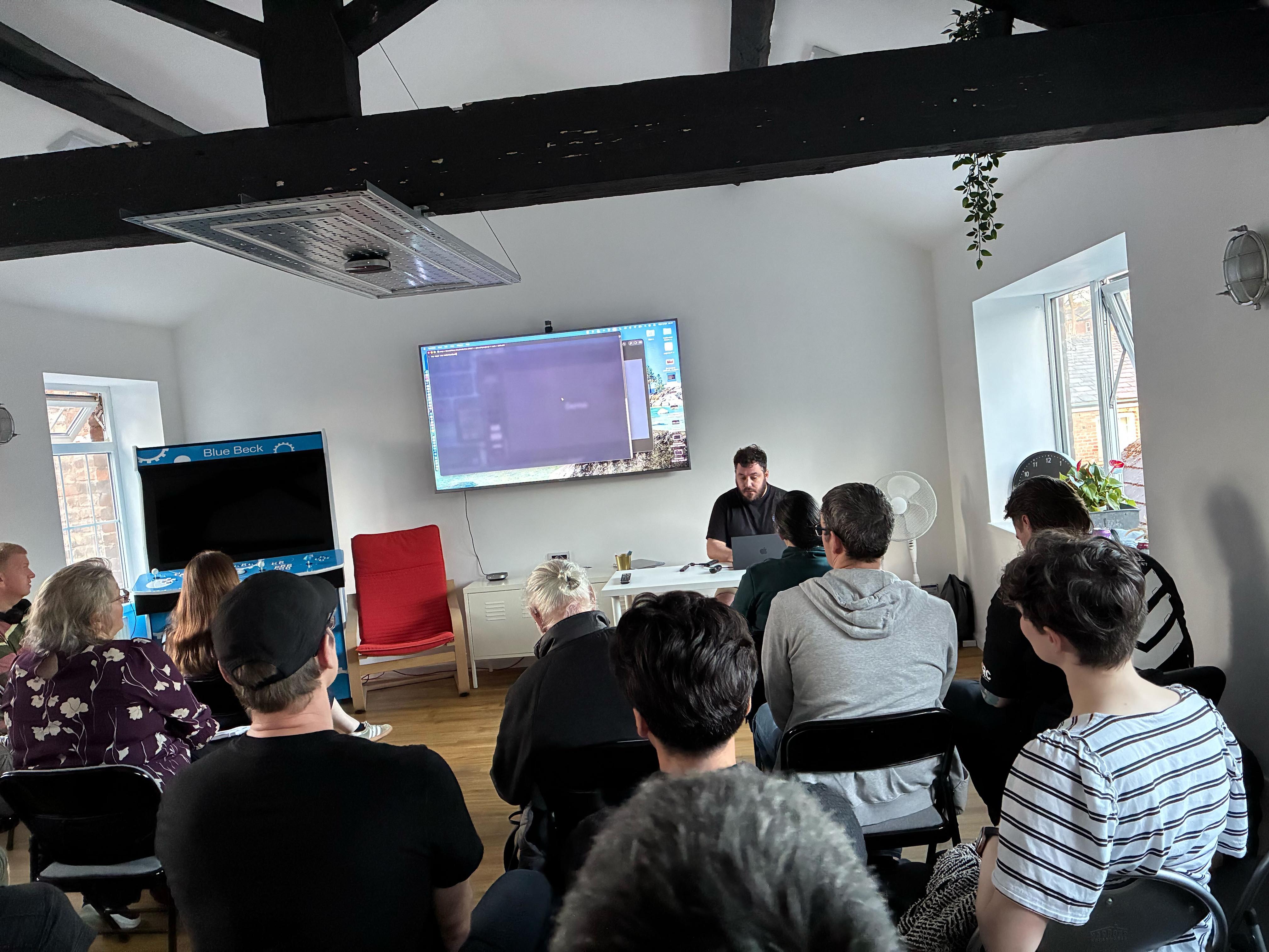 Tim sits to perform live coding