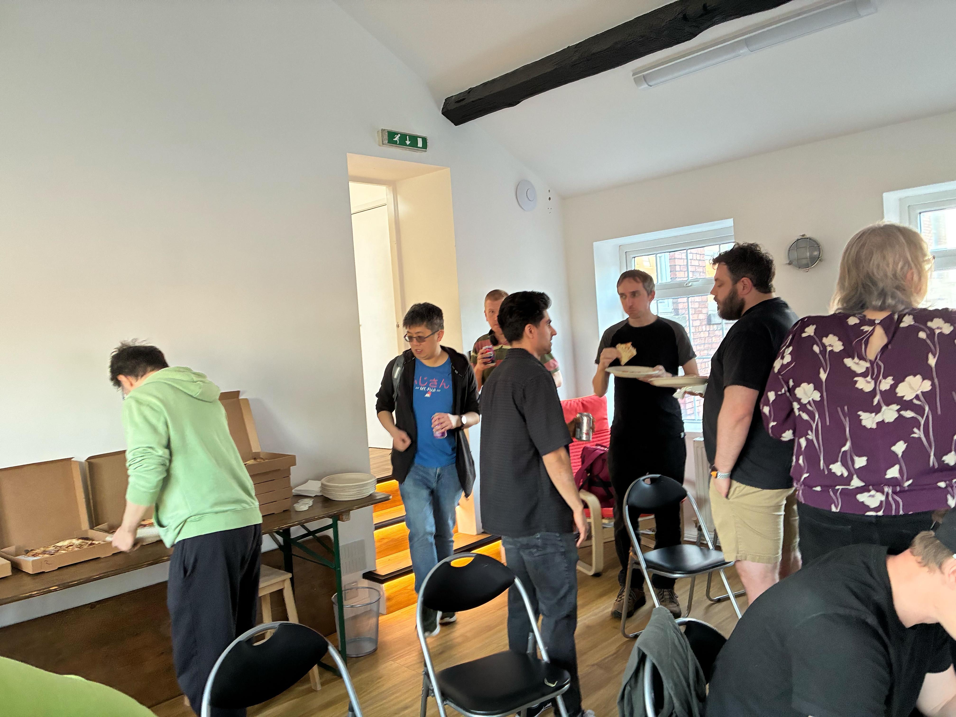 Guests enjoying the complimentary pizza